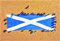 Pictures: Dramatic images captured as monster Saltire flag is unfurled on Dunnet beach