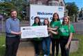 Fundraising girls hand over bumper cheque for Macmillan