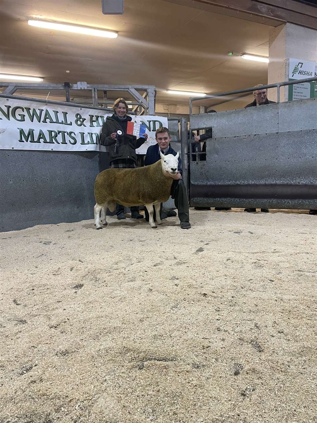 Morven Coghill, Blingery Farm, pictured with trainee Adam Mackillop, took the overall champion prize at the annual ram sale in Dingwall.