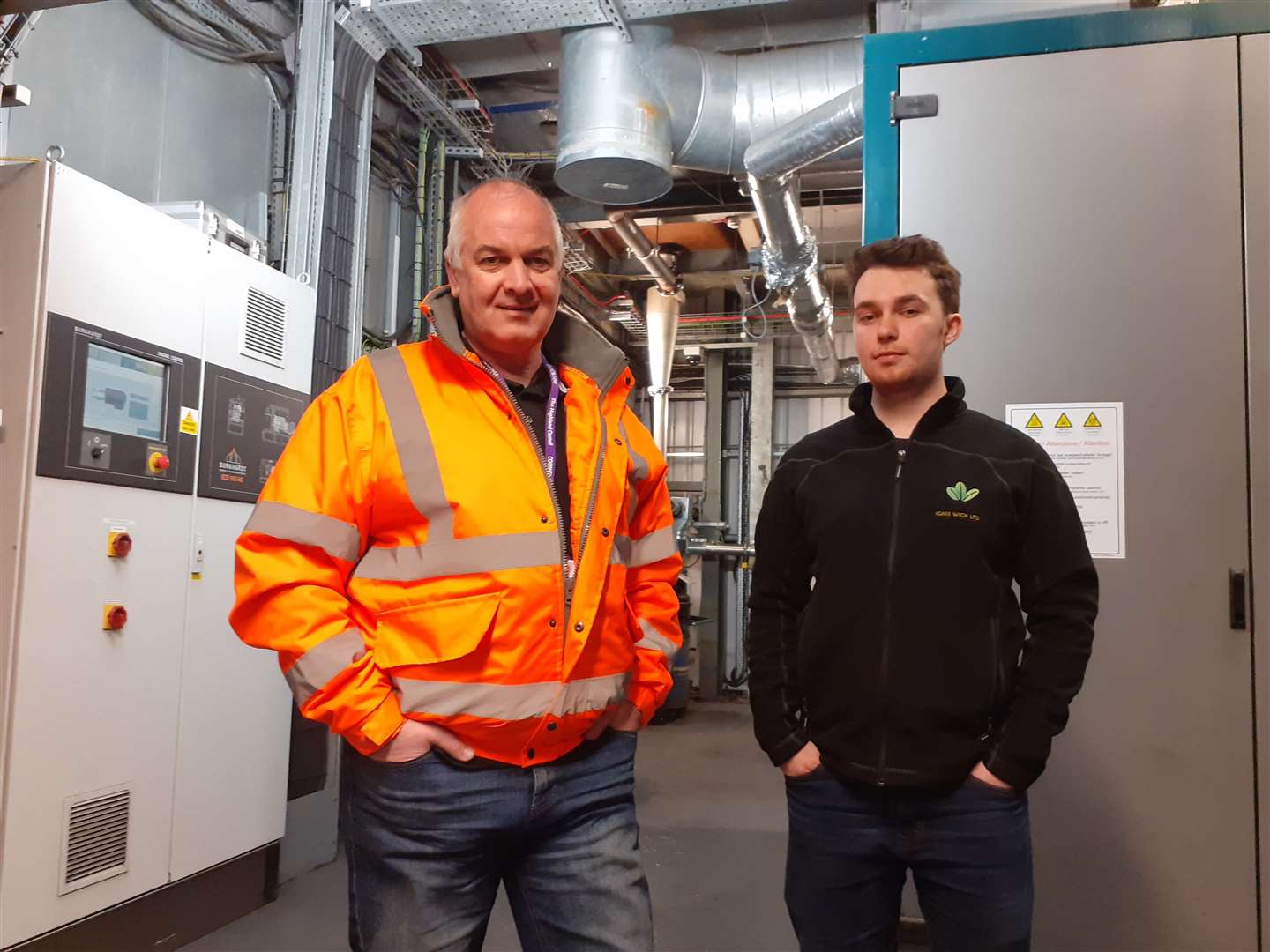 Councillor Raymond Bremner (left) and Harris Gilmore, manager of Ignis Wick Ltd, inside the biomass plant. Picture: Alan Hendry