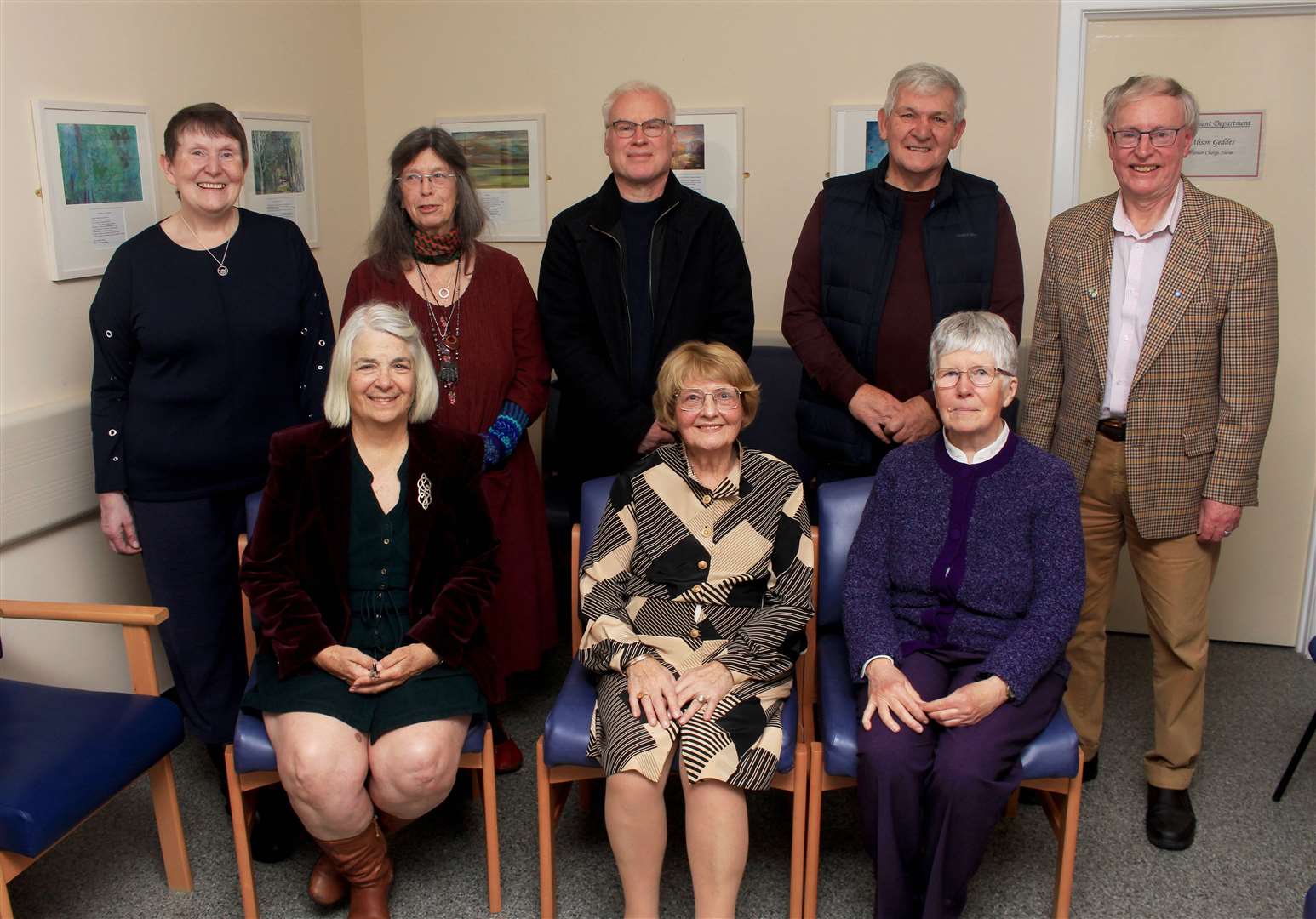 Some of the artists and writers in the outpatient waiting area at Caithness General Hospital with senior charge nurse Alison Geddes (standing, left) and Ian Pearson (right), chairman of the Society of Caithness Artists. Picture: Alan Hendry