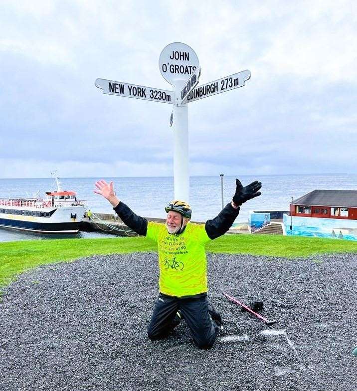The 90-year-old falls to his knees at the Groats signpost after completing the journey.
