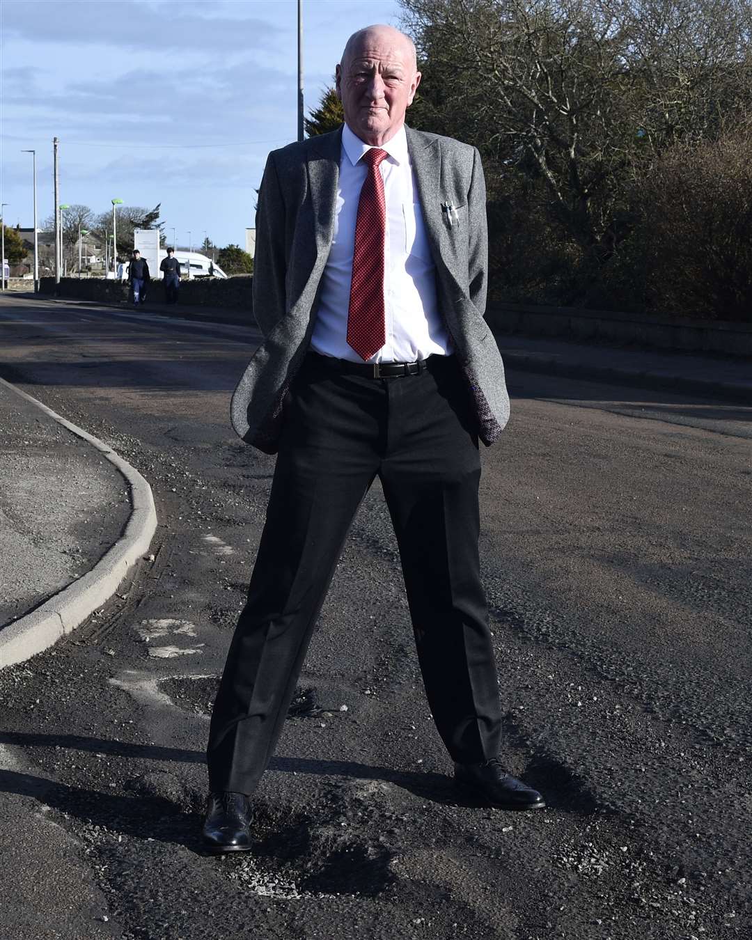 Iain Gregory standing in potholes at the junction of Henderson Street and Ormlie Road in Thurso. Picture: Mel Roger
