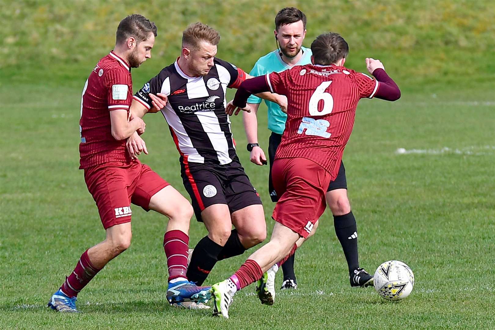 Wick captain Jack Halliday is held back by Keith's James Brownie as Nathan McKeown drives through. Picture: Mel Roger