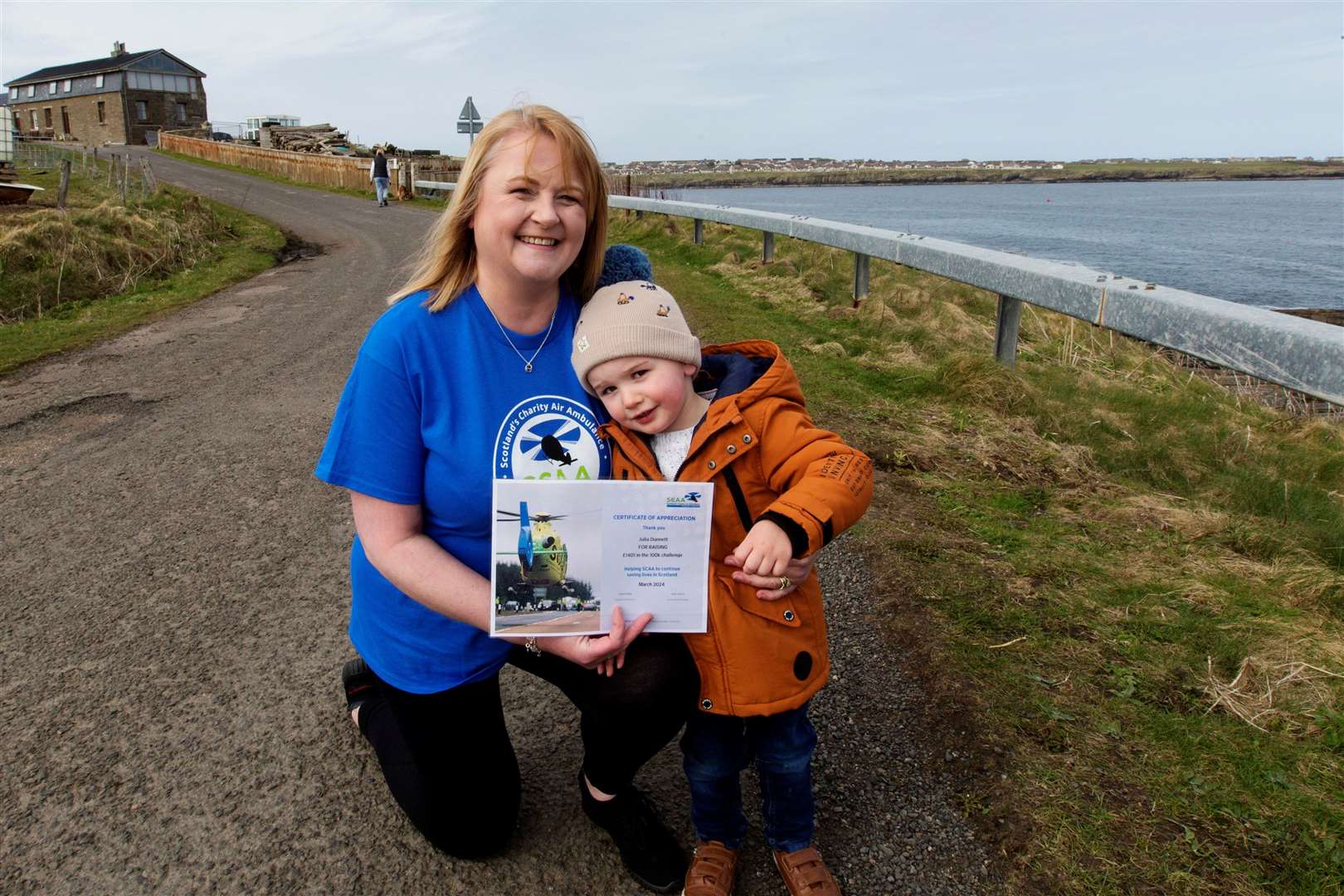 Julia Dunnett with her two-year-old grandson Danny Grant and the certificate she has received after walking 211k and raising £1401 for Scotland's Charity Air Ambulance. Picture: Robert MacDonald / Northern Studios